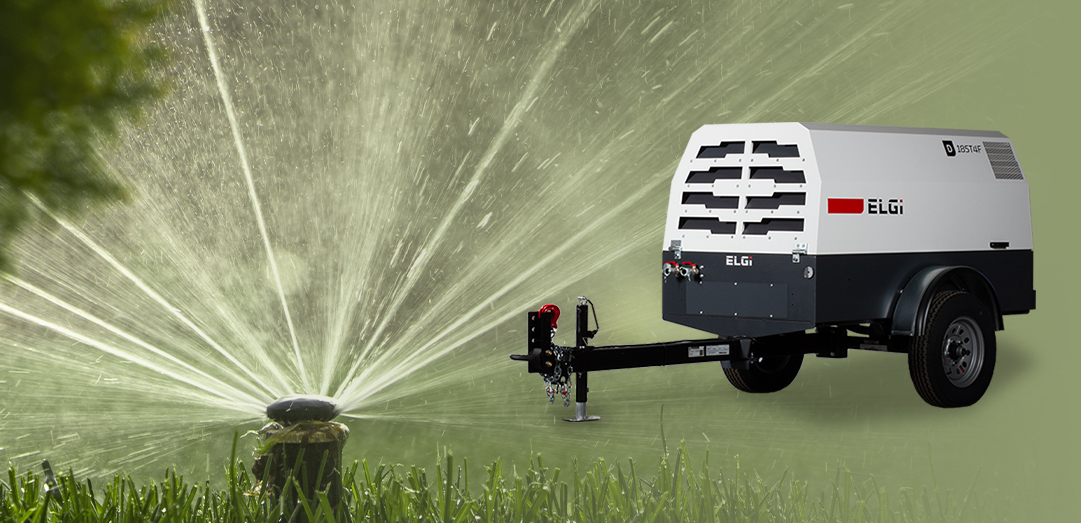How are portable air compressors used to blow out sprinklers during the fall?